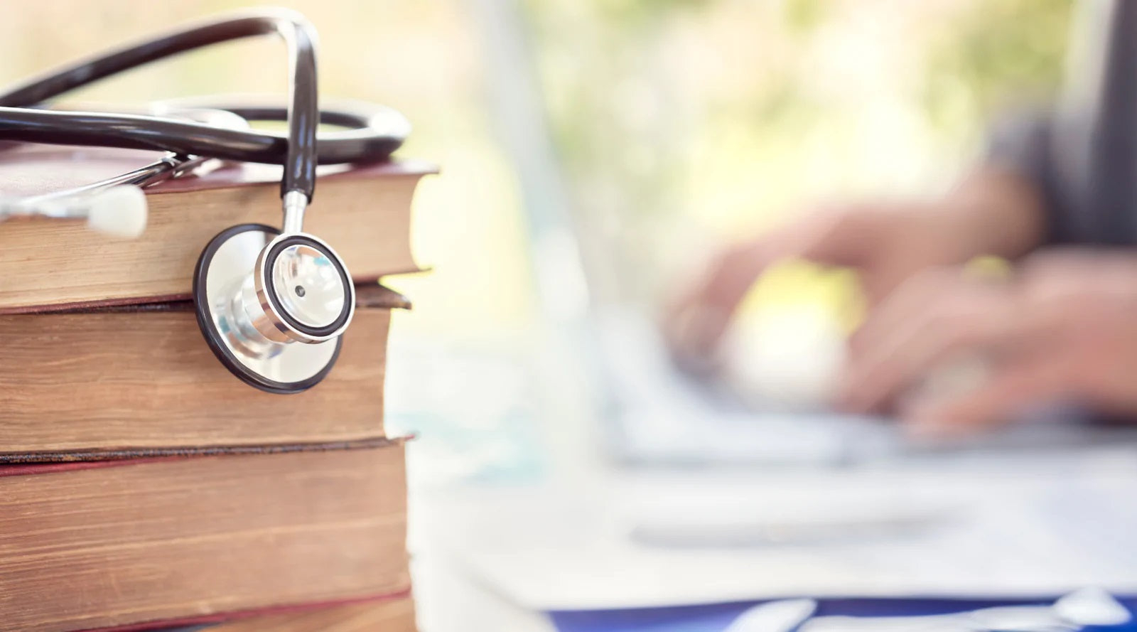 Stethoscope on top of pile of books