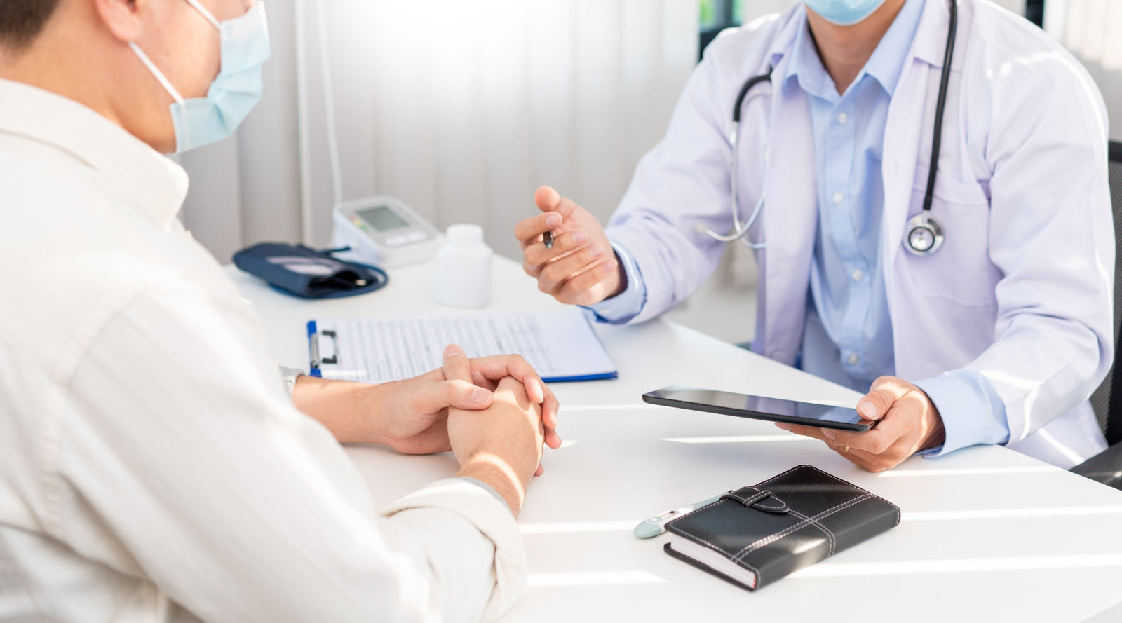 Two physicians discussing licence revocation due to conduct during COVID-19 pandemic