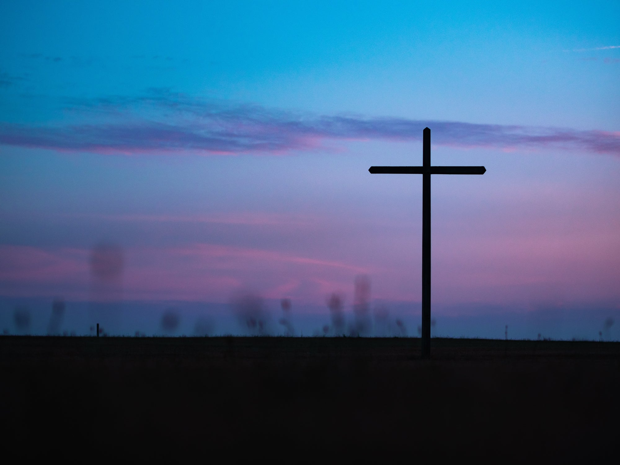 a large cross at dusk, representing the Catholic faith