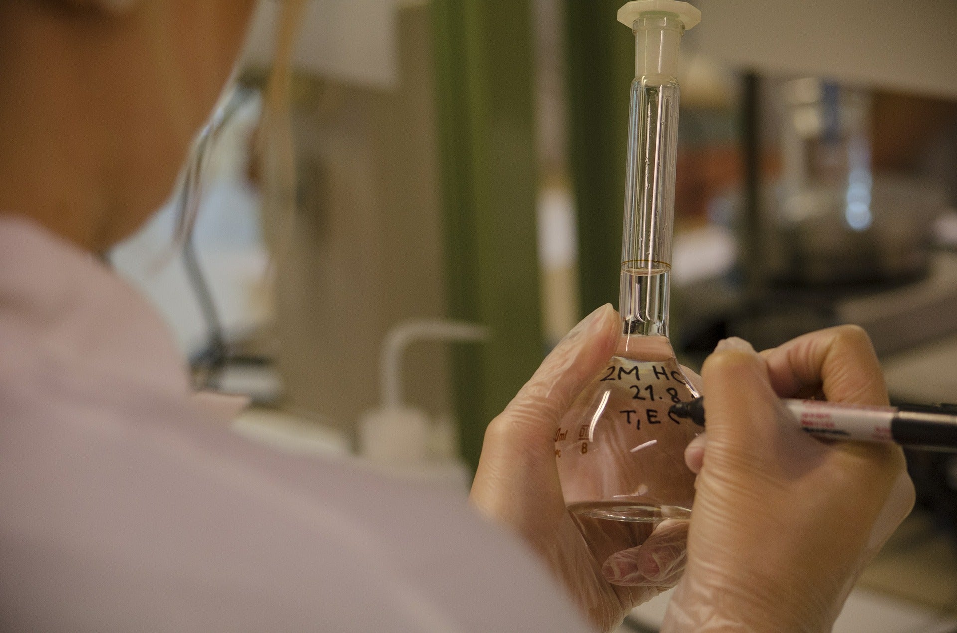 a person in a medical lab labelling a vial for in vitro fertilization