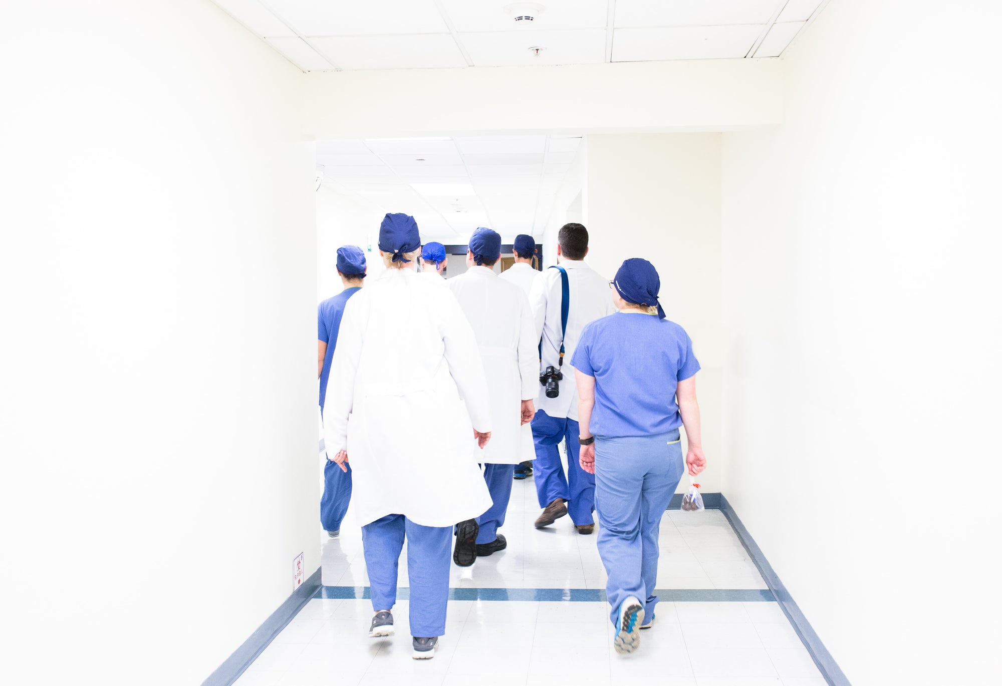 Medical staff walking down a hospital hallway