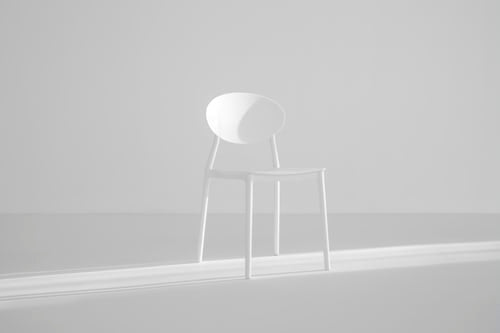 An empty white chair representing the absence of a patient's input with respect to their own treatment